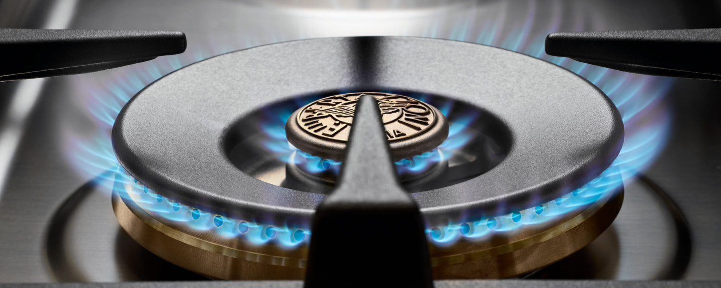 Close-up of MAS126G2ENET Bertazzoni gas burner with blue flame on stainless steel stove